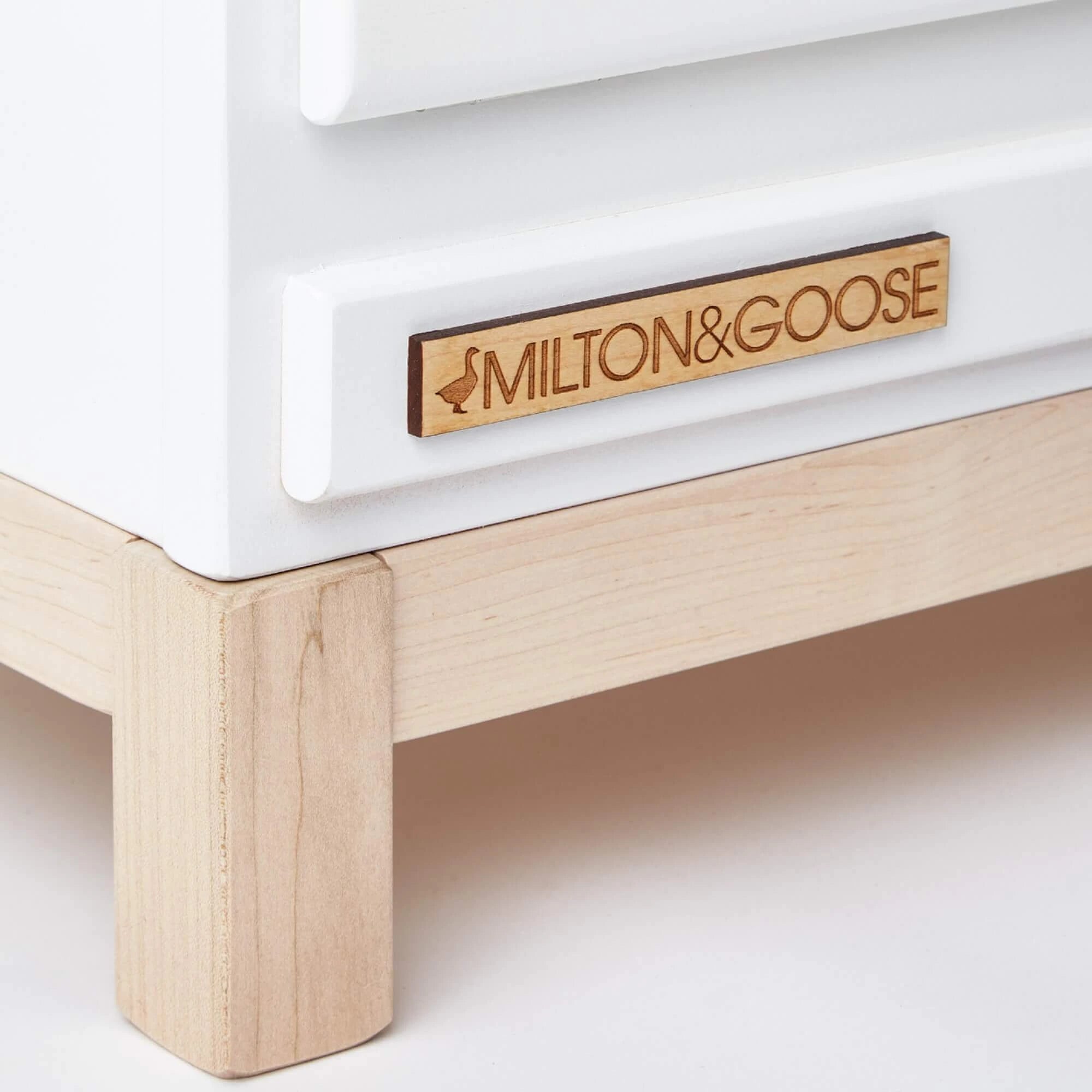 Milton & Goose Essential Play kitchen closeup to see the details in the legs, paint finish, and Logo Plate. This wooden play kitchen is made with Baltic Birch Plywood and North American Maple wood.