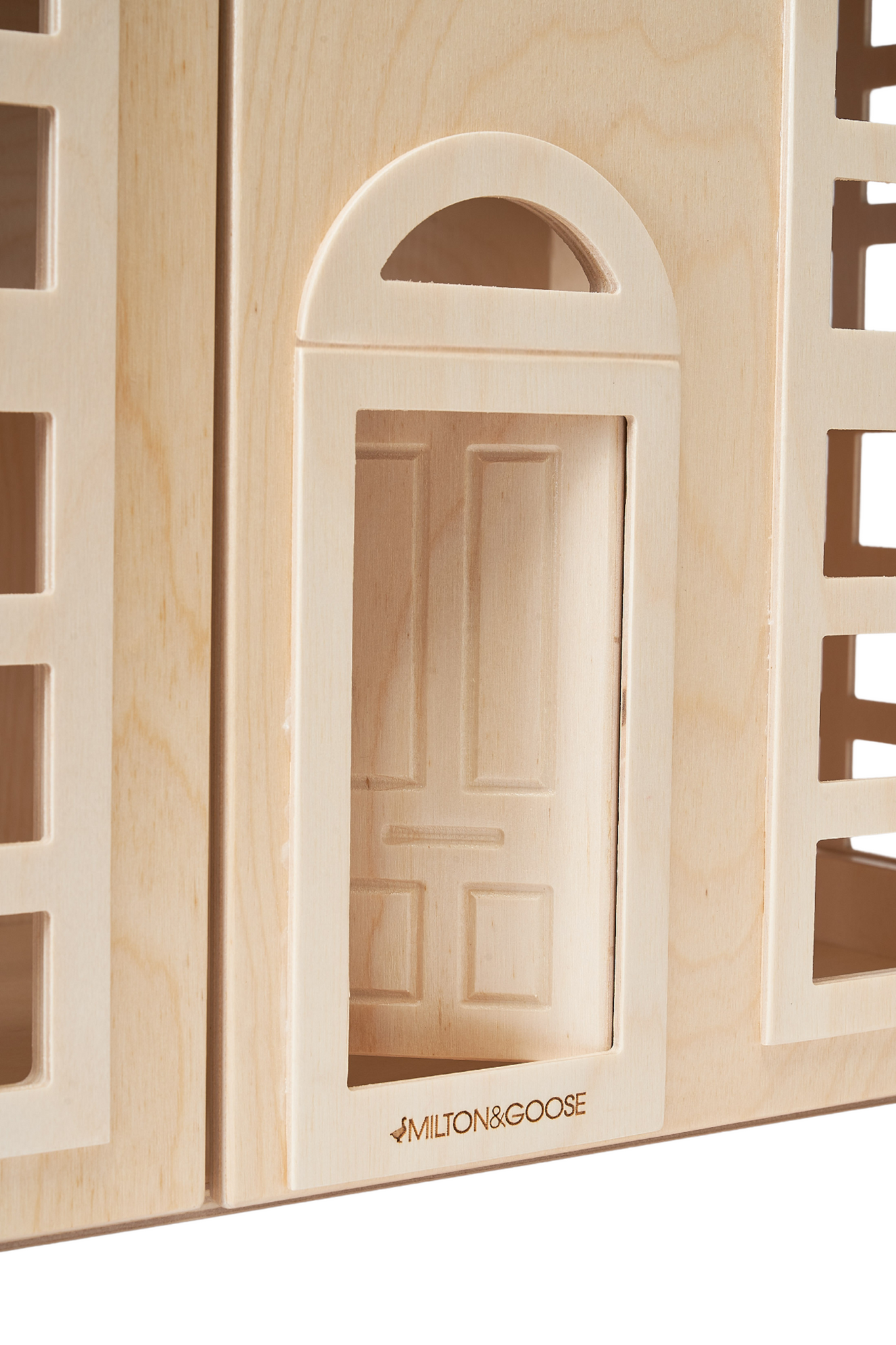 A zoomed in photo shows the Hudson Dollhouse arched doorway with the Milton & Goose logo displayed below. 
