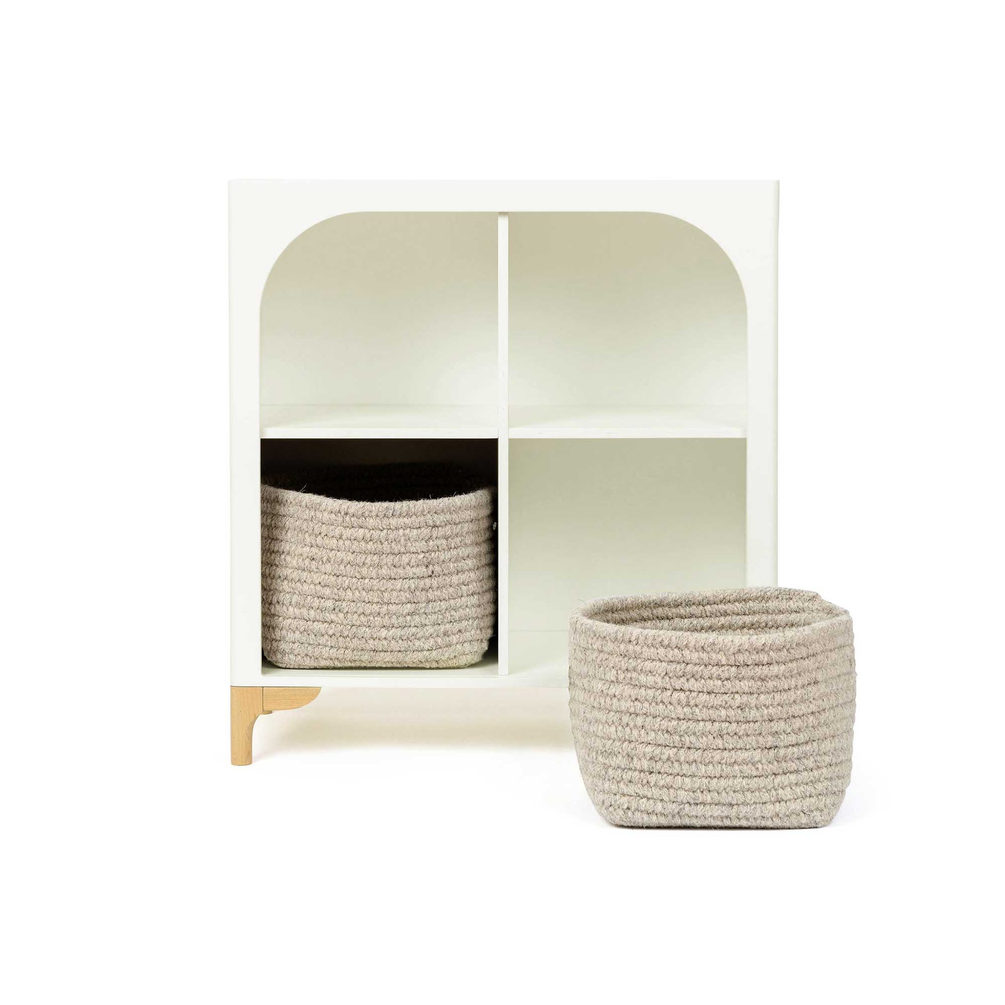 The wooden Archie Bookshelf by Milton & Goose featuring two Natural Wool Shelf Baskets.