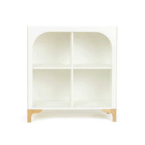 The wooden Archie Bookshelf in white sits facing forward so you can see the beautiful arch effect that frames the cubby shelves.