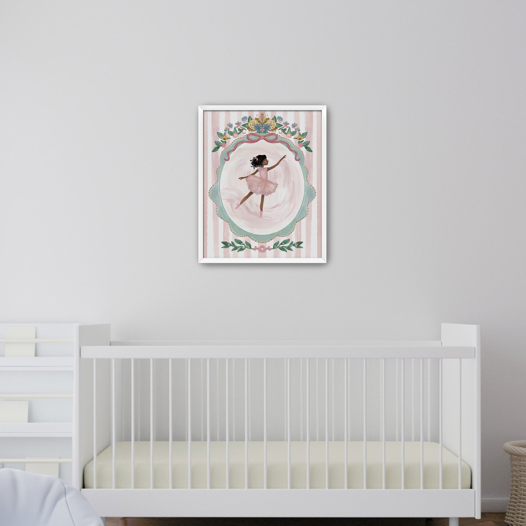 Framed artwork of a ballerina in a nursery with a crib below.