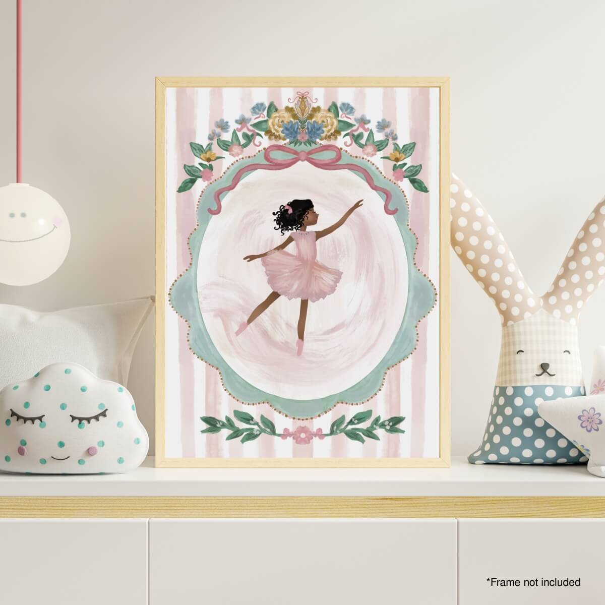 Framed artwork of a ballerina in a decorative frame on a shelf with soft lighting. Image for demonstration purposes only - frame not included as noted.