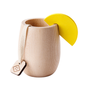 A wood play cup with a faux tea bag and wood lemon wedge by Milton & Goose.