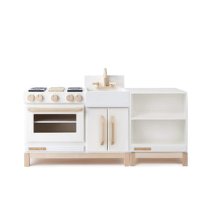 The wooden Essential Play Kitchen Countertop in White is shown next to the Essential Play Kitchen in White. Both are facing forward. 