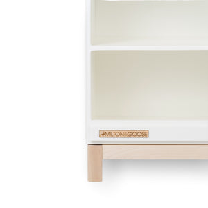 Close up of the bottom cornder of the wooden play kitchen countertop add-on for the Essential play kitchen by Milton & Goose in white on a white background