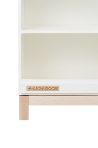 The wooden Milton & Goose logo found on the Essential Play Kitchen Countertop is shown in a zoomed in photo, facing forward. 