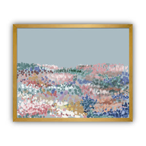 Framed abstract artwork with multicolored dots on a light blue background in a gold frame.