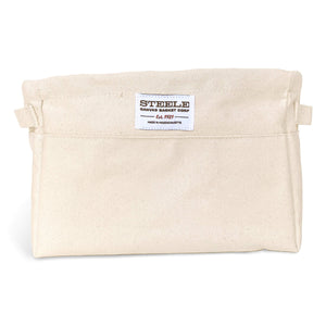 Beige canvas bin with two handles on a white background