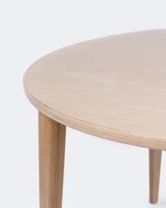 Close up of the Milton & Goose Round Crescent table in natural wood.