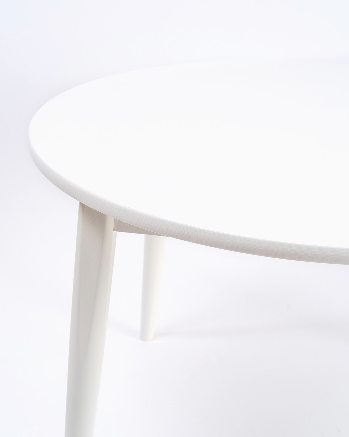 Close up of the Milton & Goose Round Crescent table in white.