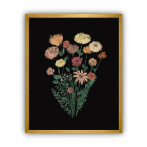 Framed artwork of a bouquet of flowers on a black background in a gold frame.