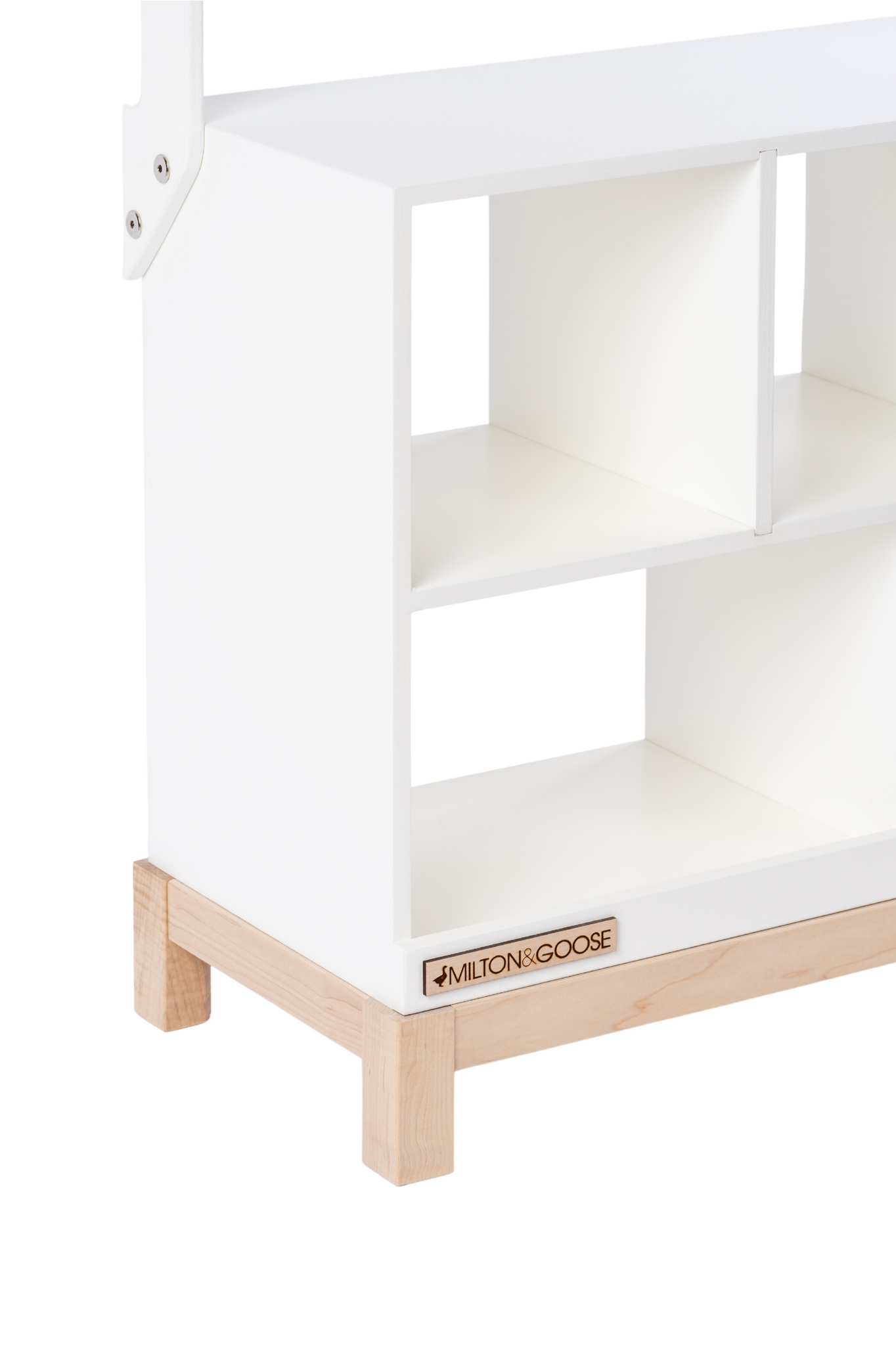 A close up image is shown of the Market Stand in white, zoomed in on a cubby and showing the Milton & Goose logo. 