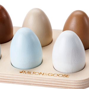 A close up of the Milton & Goose Half Dozen Egg Set in the painted colored version shows the beautiful shades of brown and blue of each wood pretend egg.