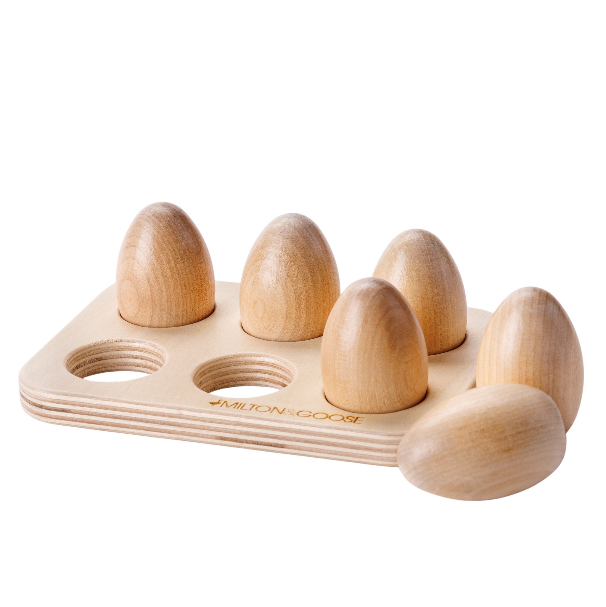 The Milton & Goose Half Dozen Egg Set shows off the wood grain in a clear finish. Two eggs sit outside of the coordinating wooden tray.