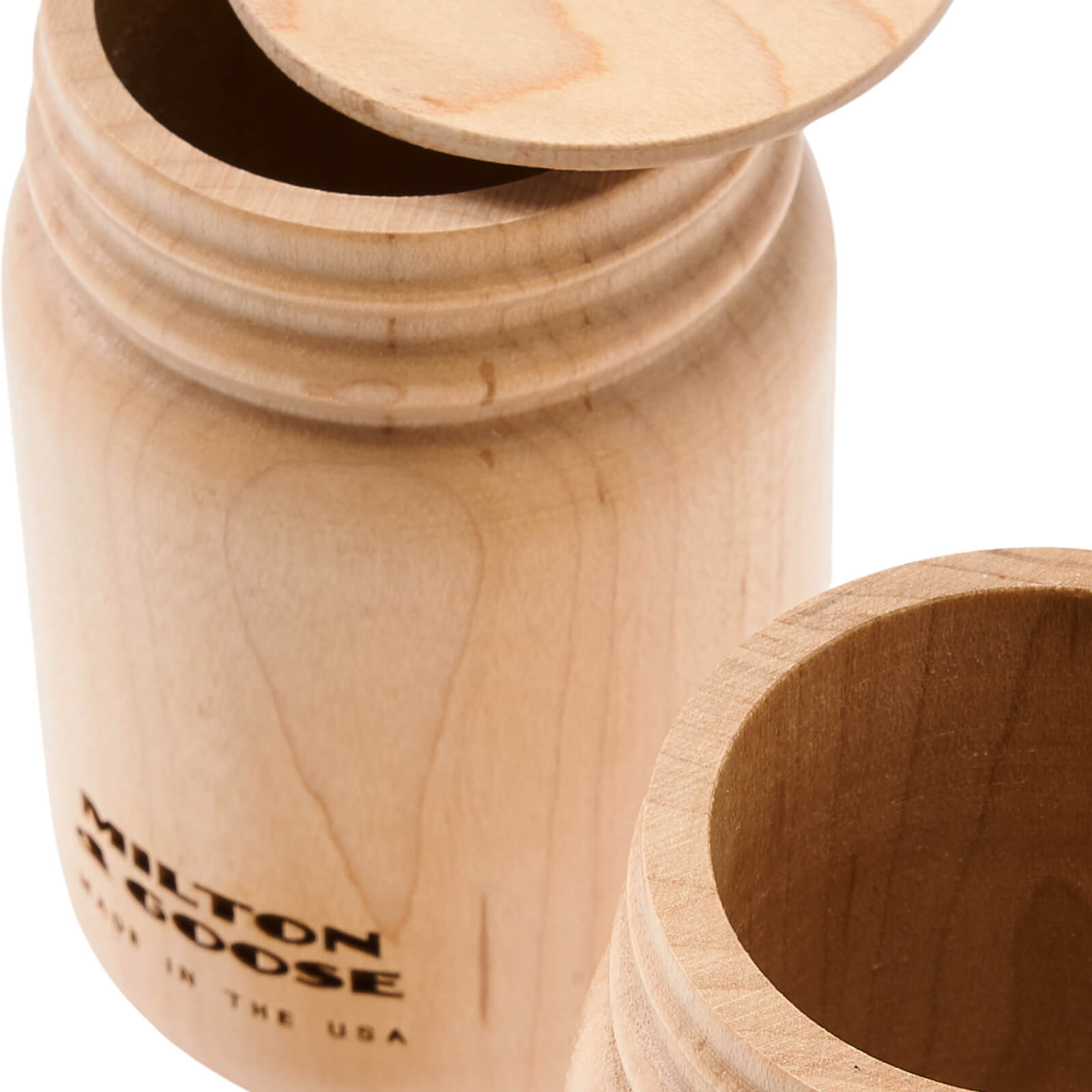 A close up of 2 wooden mason jars with flat lids. Jars are laser engraved and finished with a clear finish.