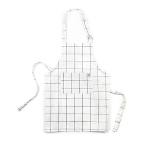 A child's apron in a gray window pane print.