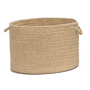 Round braided wool storage basket in the color muslin.