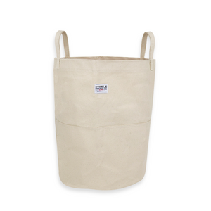 Tall canvas storage bin with handles on a white background