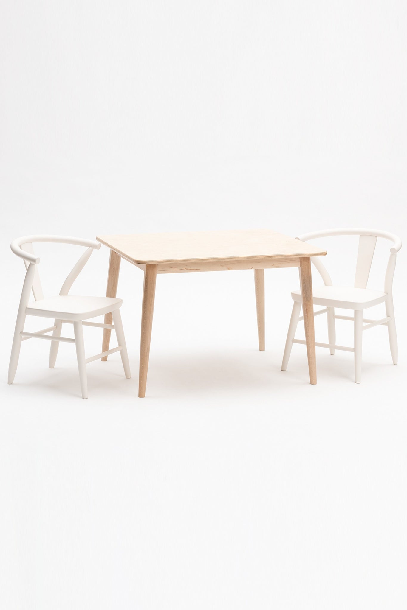 Milton and Goose Crescent Children's table in natural wood finish and chairs painted in white.  Made with sustainable materials and non-toxic finishes.